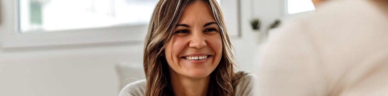 Smiling woman, talking to psychologist, feeling positive.